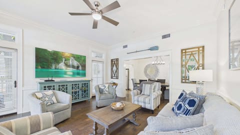 Open concept living area with ample seating and stylish furnishings along with huge TV