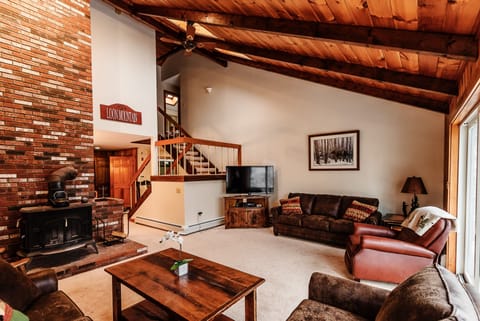 Spacious living area with 20’ cathedral ceilings.  Older picture (new hardwood)