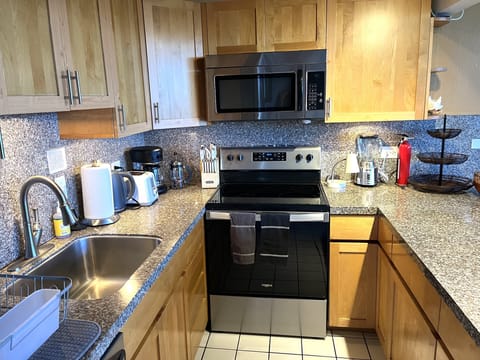 Modern kitchen with stainless steel pots and appliances.