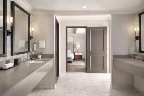 Designer toiletries, hair dryer, slippers, towels