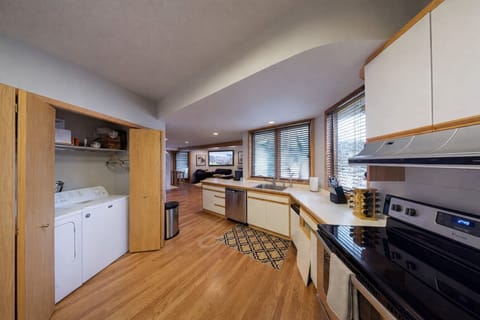 Your fully equipped kitchen features modern appliances, ample counter space, and warm wood accents for delightful home-cooked meals.