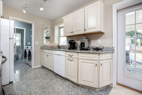 Gleaming Granite Countertrops and beachy white cabinets make cooking not such a chore.