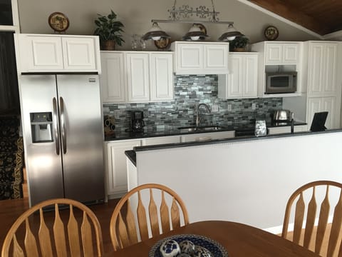The new kitchen: cabinets, counter tops, back splash and appliances.