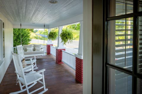 Front porch with rocking chairs and porch swing