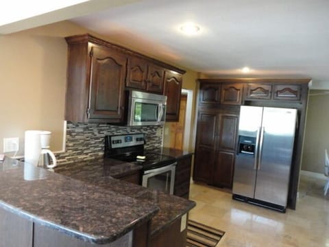 Kitchen cooktop, pantry, side by side refrigerator, pass through to dinning room