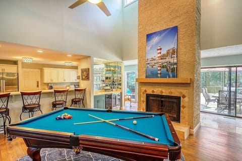 The Den with pool table and wet bar that has an ice maker and wine fridge below.