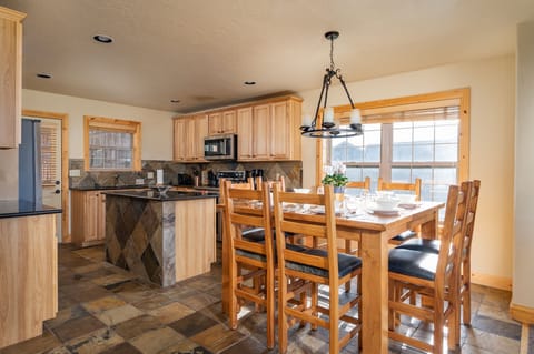 Kitchen and dining area, granite flooring, stainless steel appliances, the bonus room with a gas fireplace, gas grill and heater are located just off the kitchen.