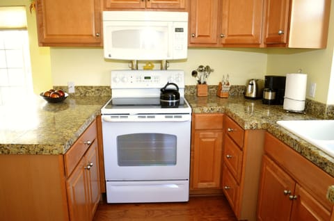 Cozy kitchen with all amenities included. Side patio located off of kitchen.
