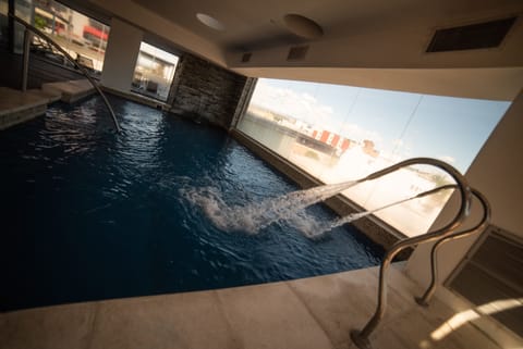 Indoor pool, open 1:30 PM to 8:30 PM, pool umbrellas