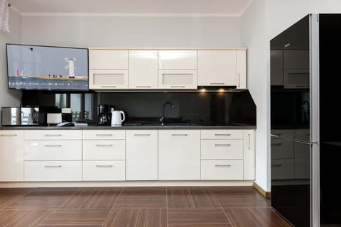 White furniture and high-quality appliances ensure a comfortable stay with the possibility of cooking meals.