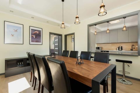 Large table with chairs for eating communal meals. 