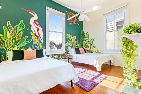This bedroom features two queen beds and gets an a ton of natural light.