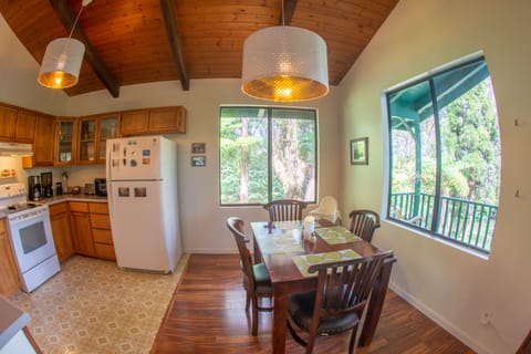 Spacious dining area with large windows to take in the forest views.