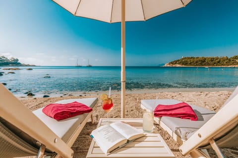 Private beach, white sand, sun loungers, beach umbrellas