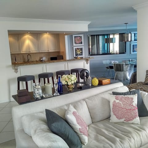 Open kitchen, breakfast counter and dining area from the living room area.