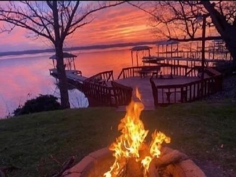 Outdoor fire pit as the sun sets over the lake 