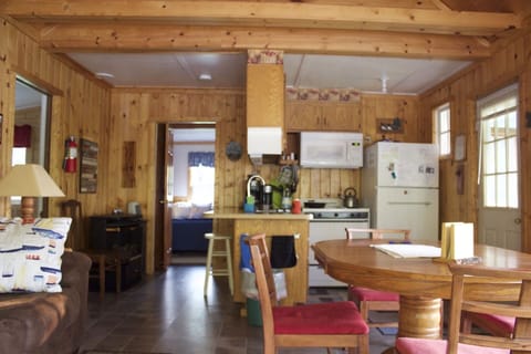 Open kitchen and dining area.  Kitchen has full size refrigerator and gas stove.