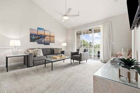 Bright, open living room with vaulted ceilings and golf course views