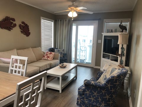 Living Room view with brand new floors to screened in porch.