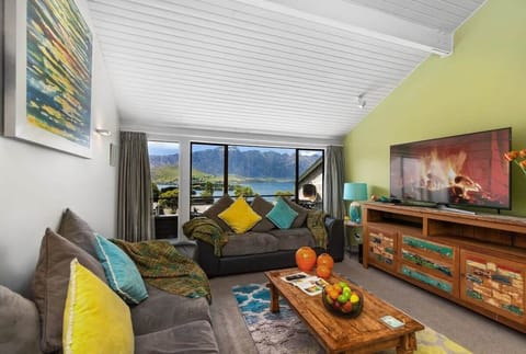 Lounge with Stunning Lake and Mountain Views: Relax in style with vibrant decor and breathtaking scenery!