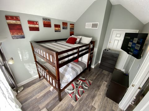 Beautiful second bedroom featuring a full-size bunk bed and its own HD TV
