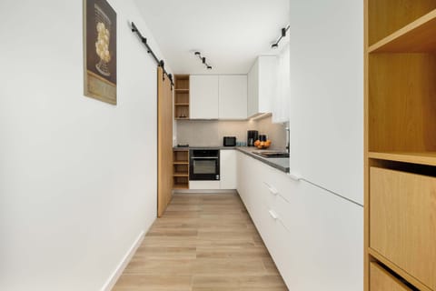 The narrow, modern kitchen equipped with appliances makes it easy to prepare any meal with comfort.