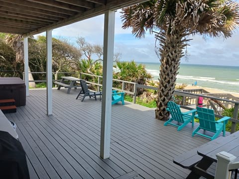 The grill, hot tub, and outdoor shower are located here on the back deck.