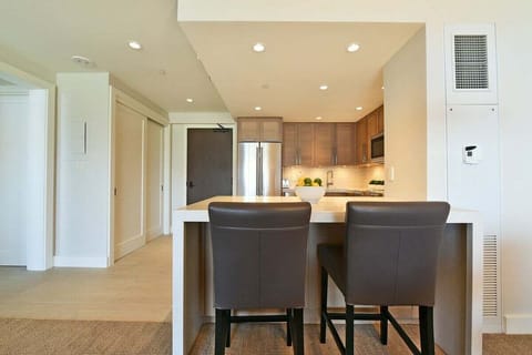 Grab a quick bite here. Simple, clean, and functional kitchen bar with stylish seating