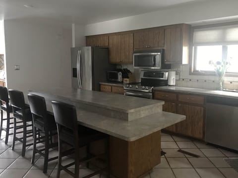 Fully stocked kitchen with large island and seating.