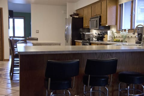 Kitchen as seen from dining room, fully open. Counter seating for 7+.