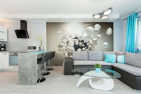 Another angle of the living room, showcasing gray furniture, decorative wall art, and a cozy setup for lounging.