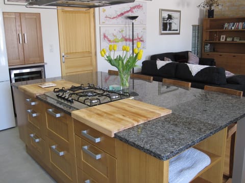 Beautiful, modern kitchen where the chef can join in the fun in the living area