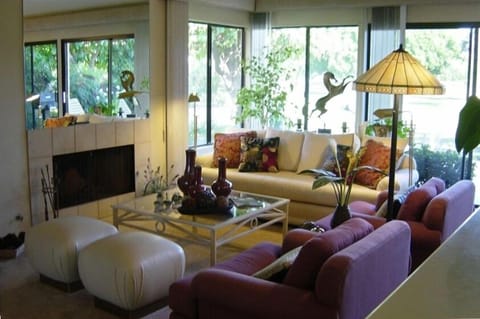 Great Room with wall to wall windows on golf course and morning sunshine.
