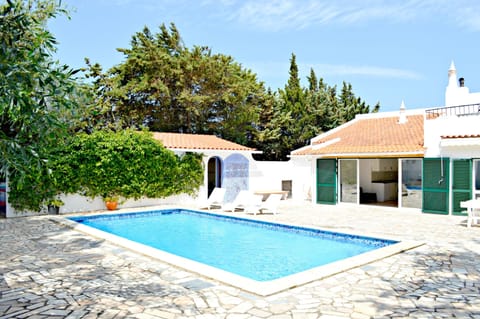 Pool area with toilet, outside shower and part view of kitchen