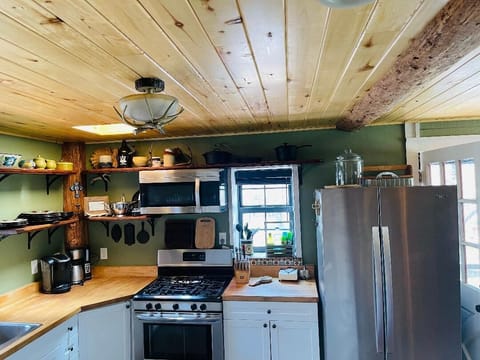 Aspen ceiling beams add character to the kitchen, open to the dining area.