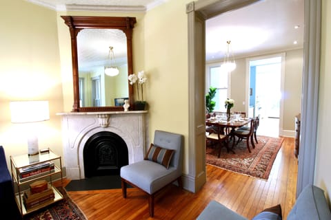 View from living area to formal dining area. Original 1890s heart pine floors