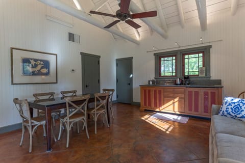Dining table and kitchen unit. The fridge is in the pantry just behind the door.
