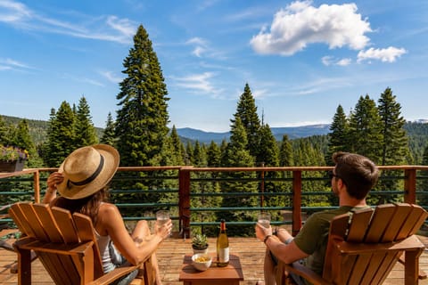 Relax on your private deck with a glass of wine and soak in stunning mountain and forest views, perfect for peaceful mornings or golden-hour evenings together.