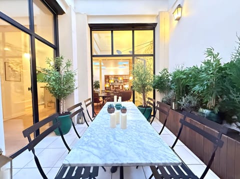 SPARIS – Patio extérieur avec ses tables bistrot et une ambiance verdoyante