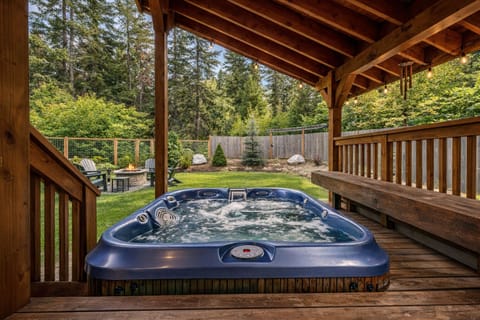 Soak in your private hot tub under the covered deck, surrounded by lush forest views and complete tranquility.
