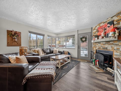 Sink into plush leather sofas by your crackling fireplace, where cozy evenings and mountain views create the perfect retreat.