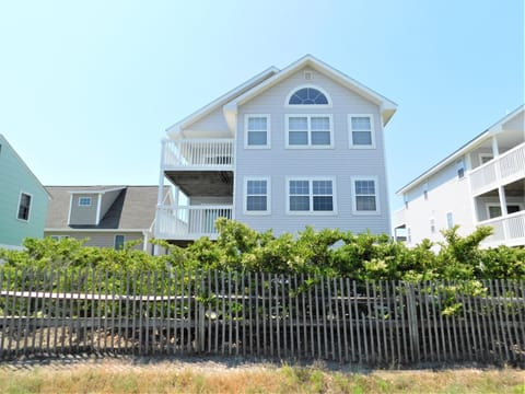 7 South Carolina Avenue - Rear Exterior View - A slightly wider side-to-rear view of the property, showing the exterior structure and coastal landscaping.
