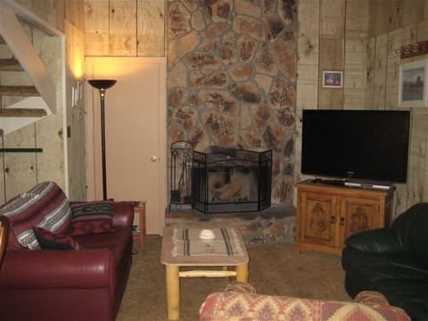 Living Area with burning fireplace and 55' screen TV.