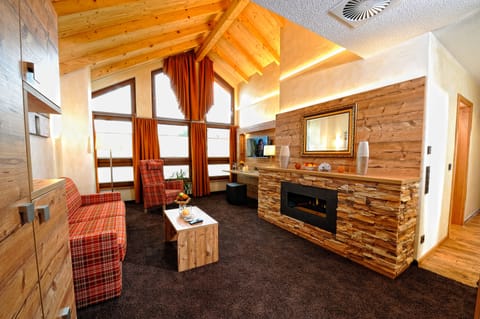 Honeymoon Suite, 1 Bedroom, Sauna | Living area | Flat-screen TV, first-run movies