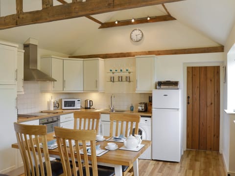 Well-equipped fitted kitchen with convenient dining area | The Stables, Occold, near Eye