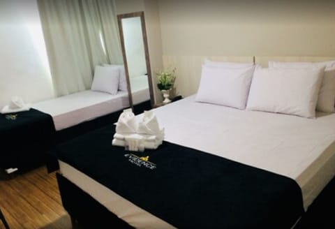 Triple Room | Minibar, individually furnished, desk, blackout drapes