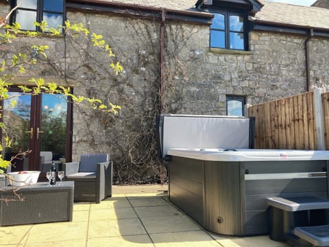 Patio area with hot tub | The Coach House, Trelawnyd, near Prestatyn