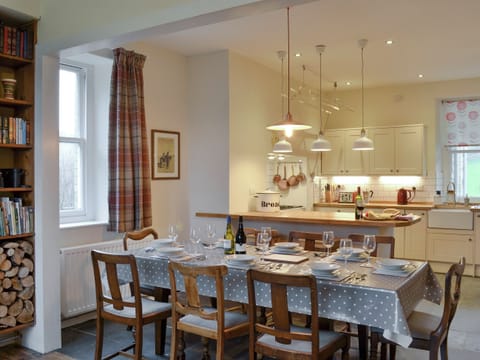 Large dining table in open plan room | Tyllwyd Farmhouse, Capel Bangor, near Aberystwyth