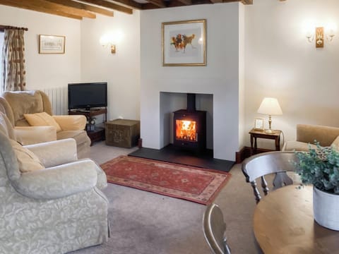 Living room with a cosy open fire | Ellerbeck Cottage - Swaledale and Ellerbeck Cottages, Caldbeck, near Keswick