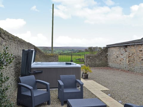 Relax in the private hot tub whilst looking out over the rolling countryside | The Cottage at Wilson House, Barningham, near Richmond